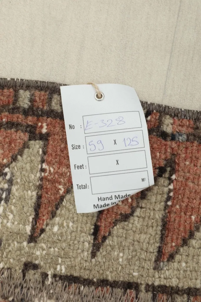 Close-up of the size tag, confirming dimensions and hand-made origin of the rug