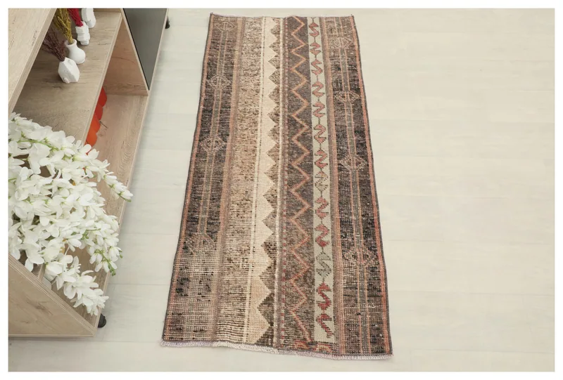 Full top view of the brown and beige striped vintage Anatolian area rug on a white background.