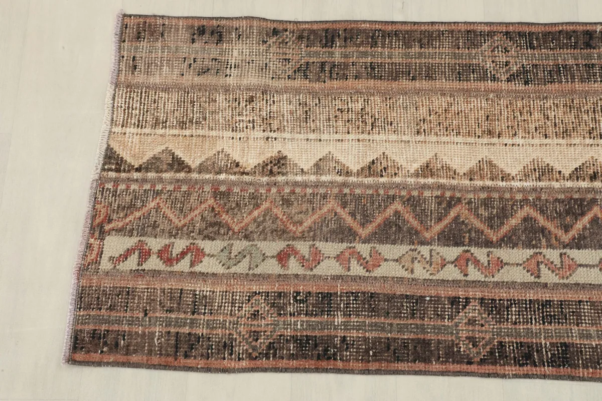 Another side view of the rug, emphasizing the varied geometric motifs within the stripes.