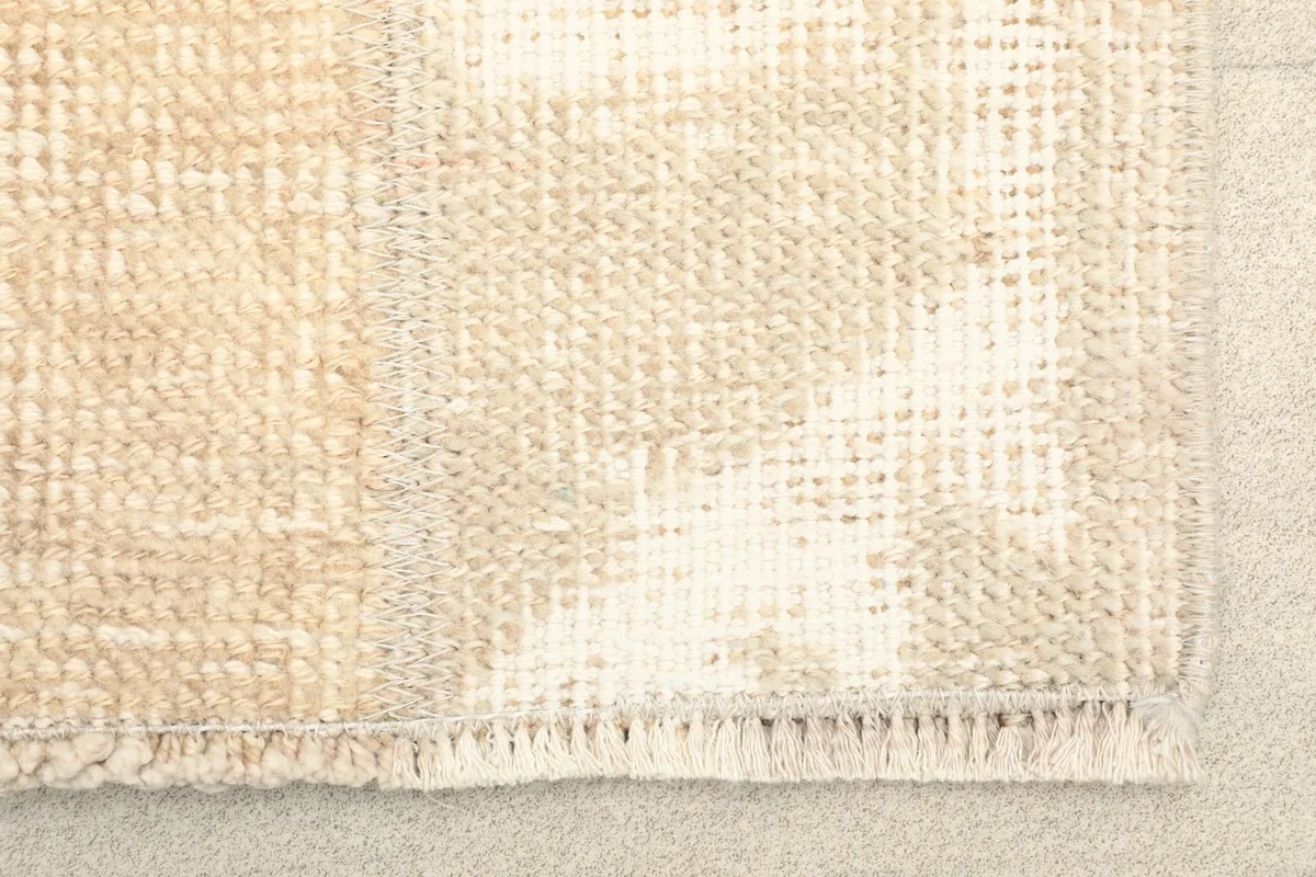 Close-up detail of the rug's texture, showing the hand-knotted wool pile and fringe