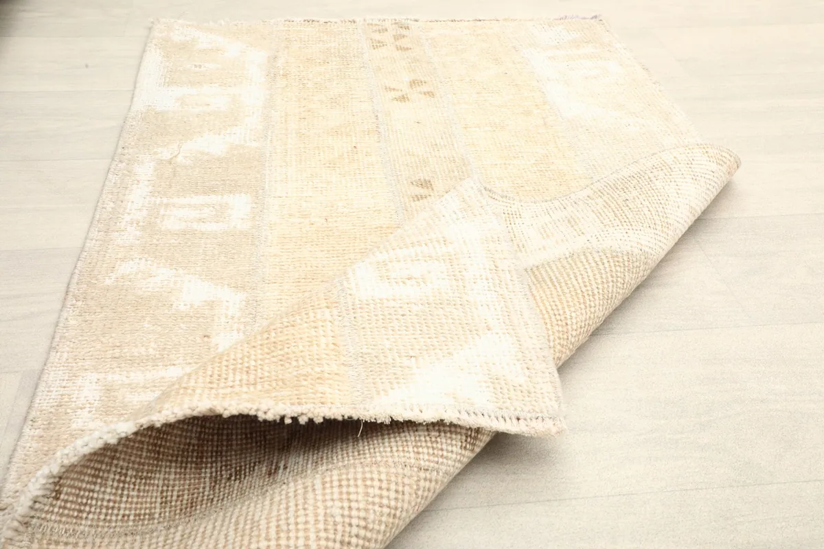 The rug folded to show the flexibility and the back of the rug