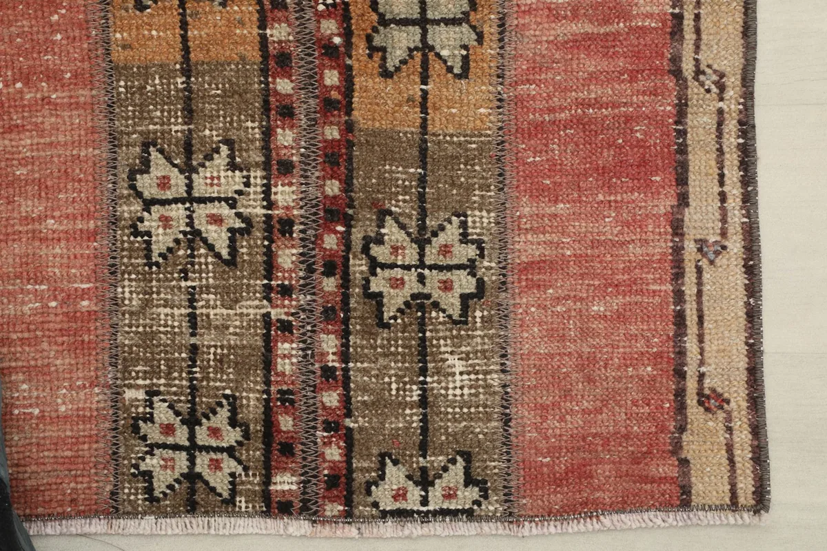 Detailed view of the central brown stripe with intricate geometric patterns and faded areas