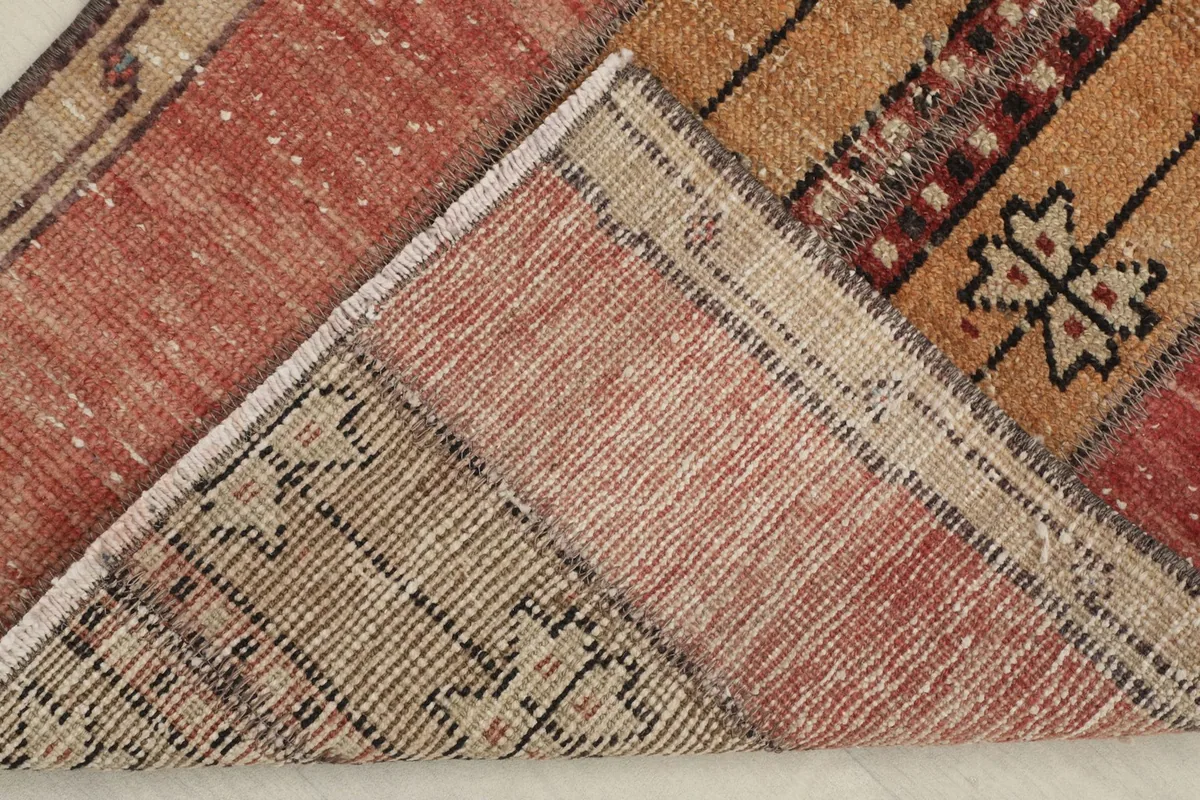 View of the rug's underside, revealing the hand-knotted cotton foundation and wool pile construction