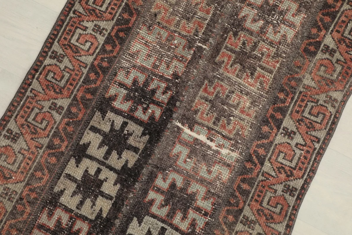 Close-up view of the central geometric patterns and color blending in charcoal, rust, and tan