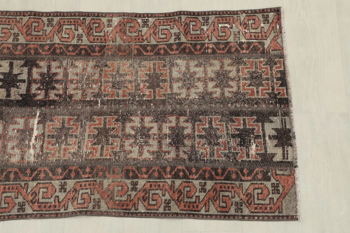 Close view of the rug's side, revealing the distinct tribal motifs and color variations