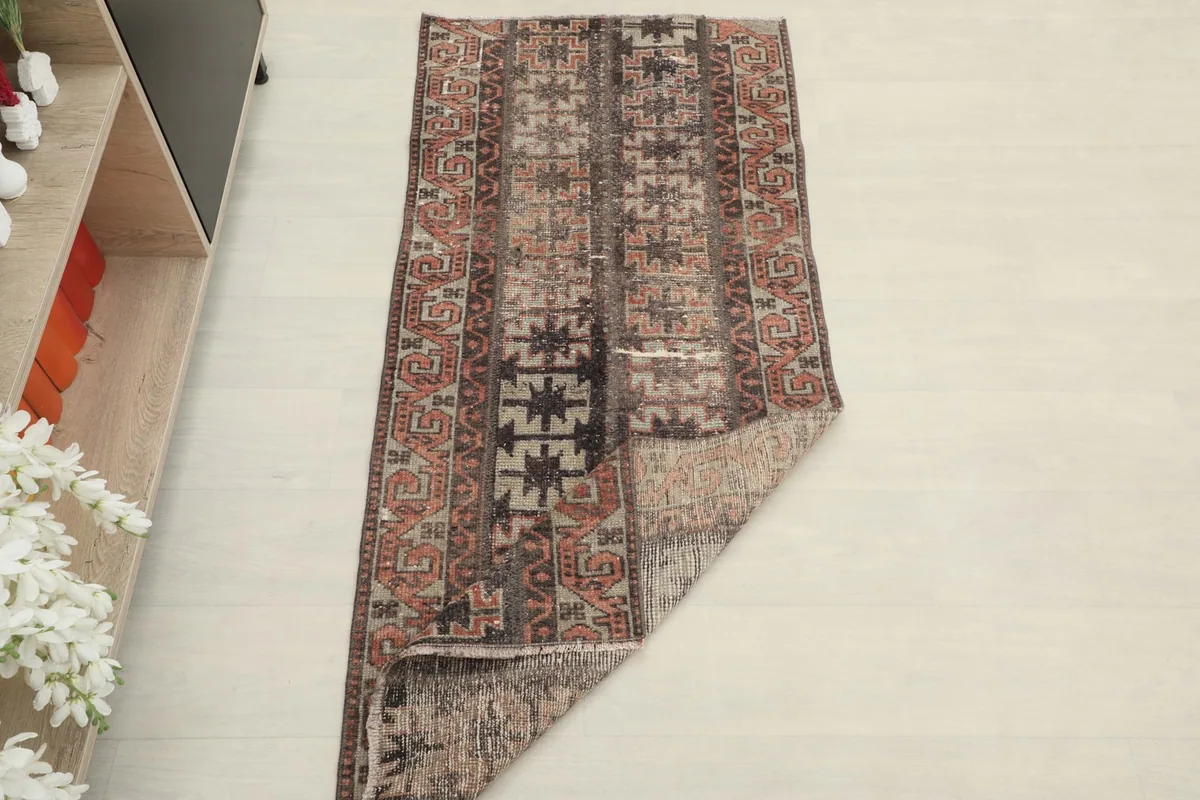 The runner rug partially folded, demonstrating its flexibility and the consistent pattern from different angles