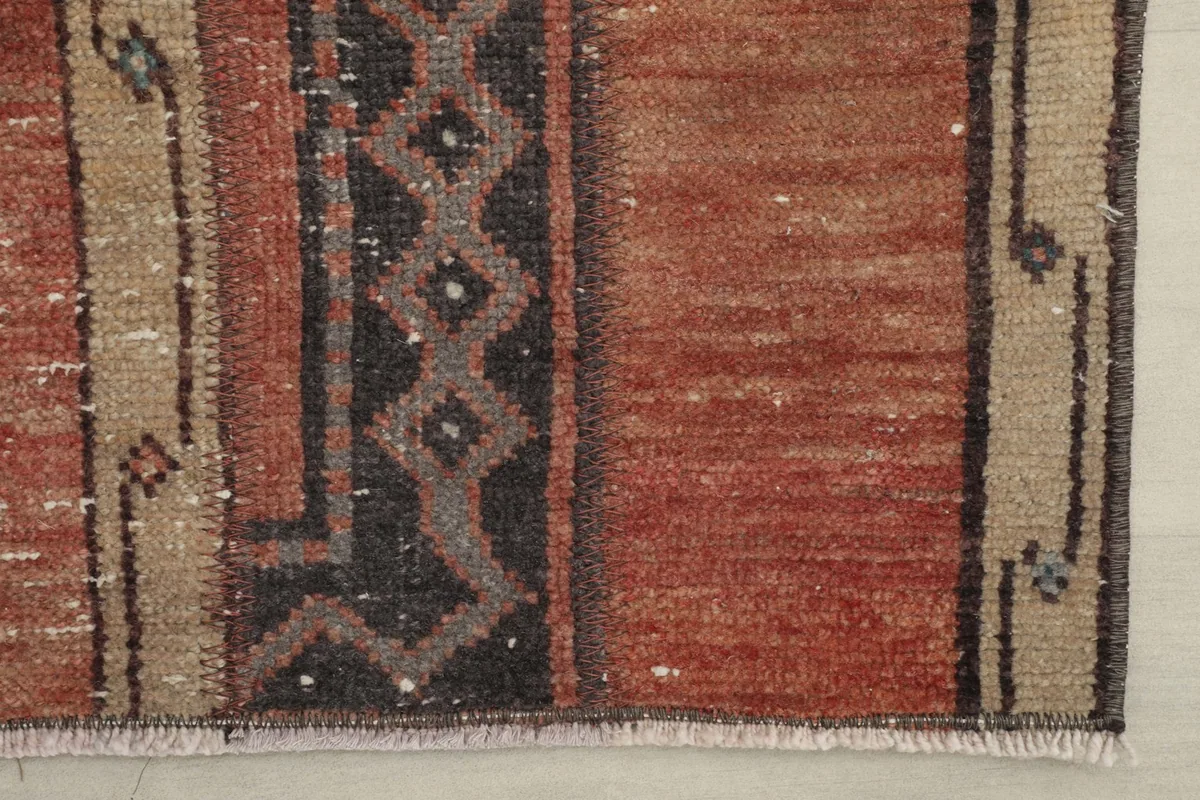 Close-up of the rug's edge, displaying the border design and fringe detail.
