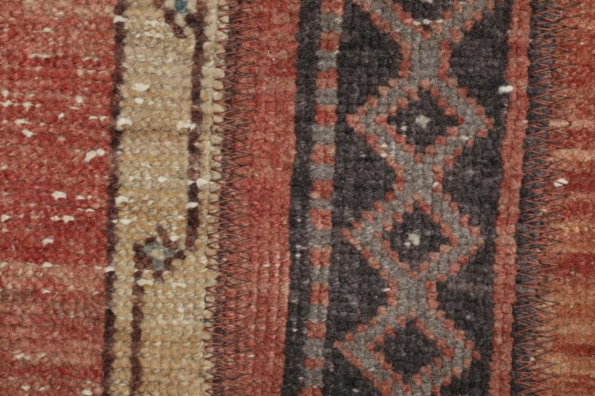 Macro view of the low wool pile, showing the individual knots and slight wear.