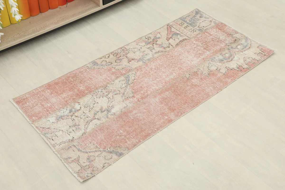 Vintage hand-knotted runner from Anatolia, showing its full length and faded rose and beige colors.