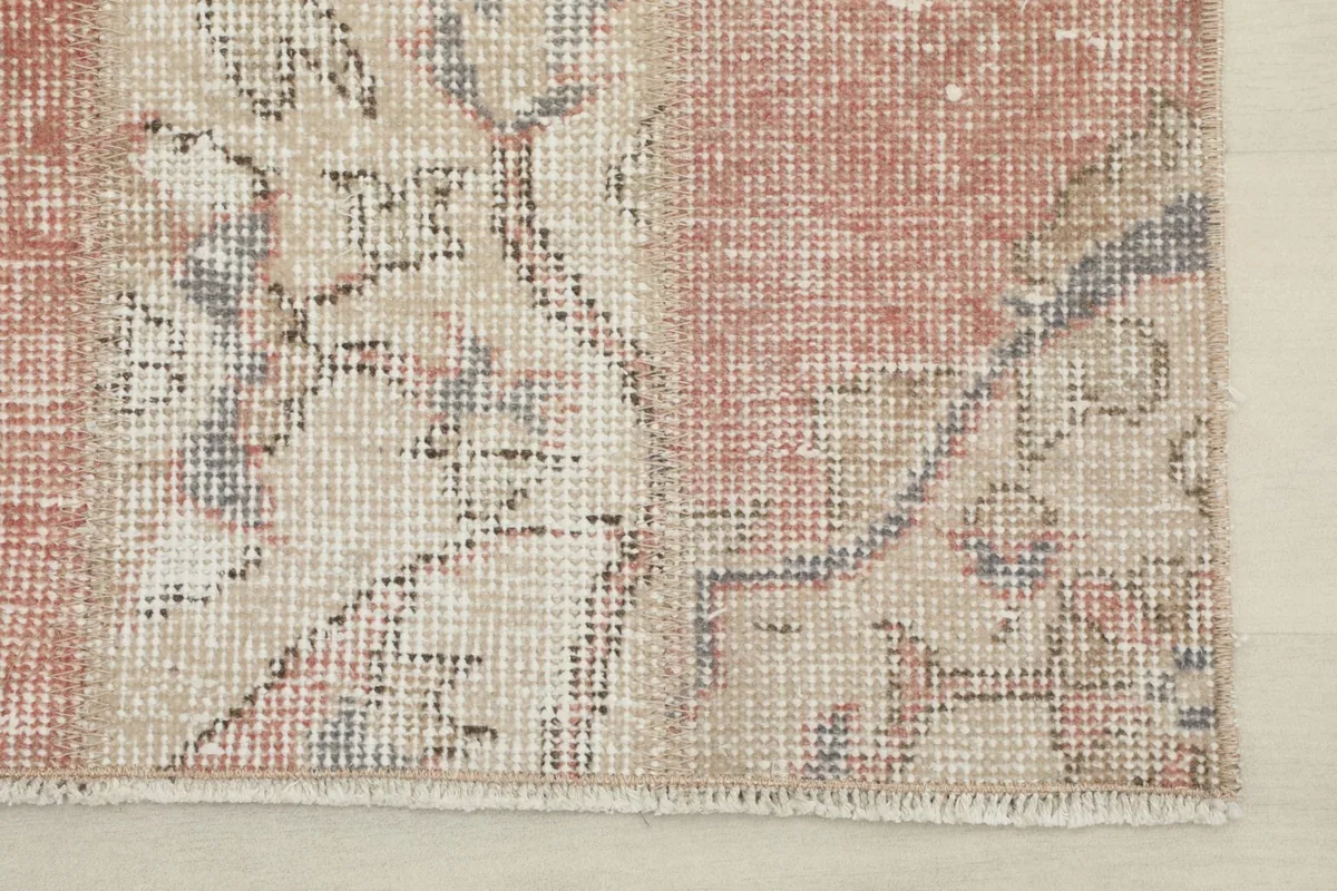 Close-up of the rug's short fringe and the tightly woven edge, indicating hand-knotted craftsmanship.
