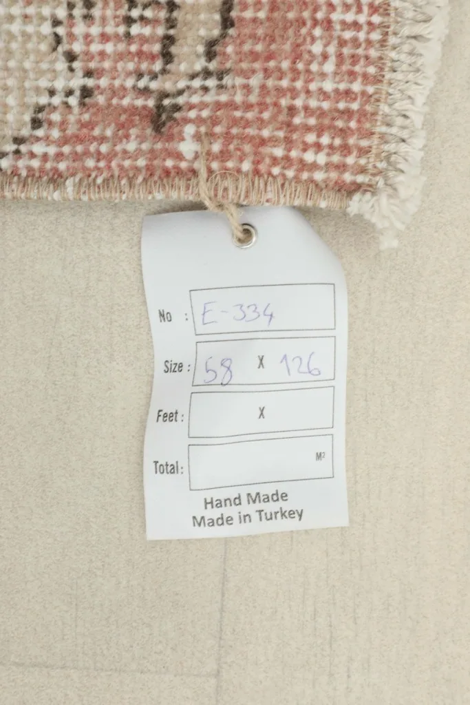 Close-up of the product tag attached to the rug, showing size and origin details.