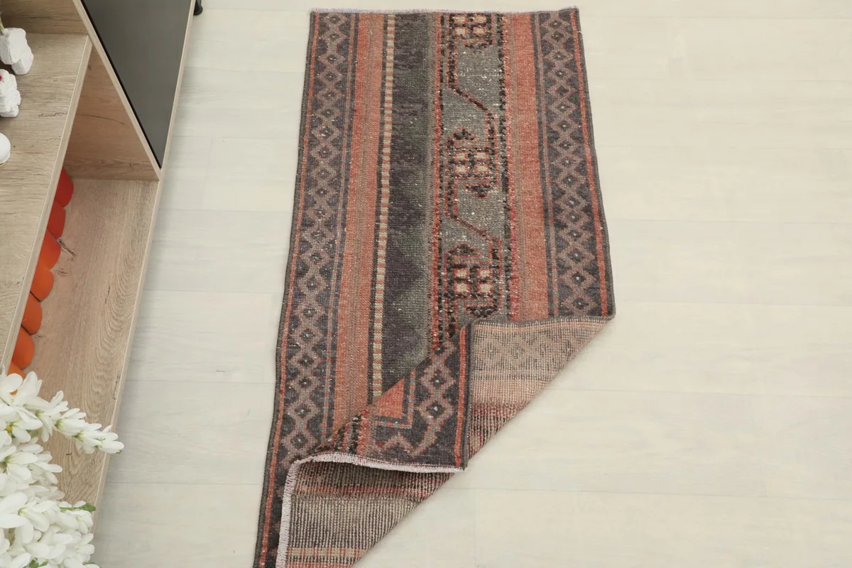 The rug partially folded, providing a sense of its size and texture in a home setting