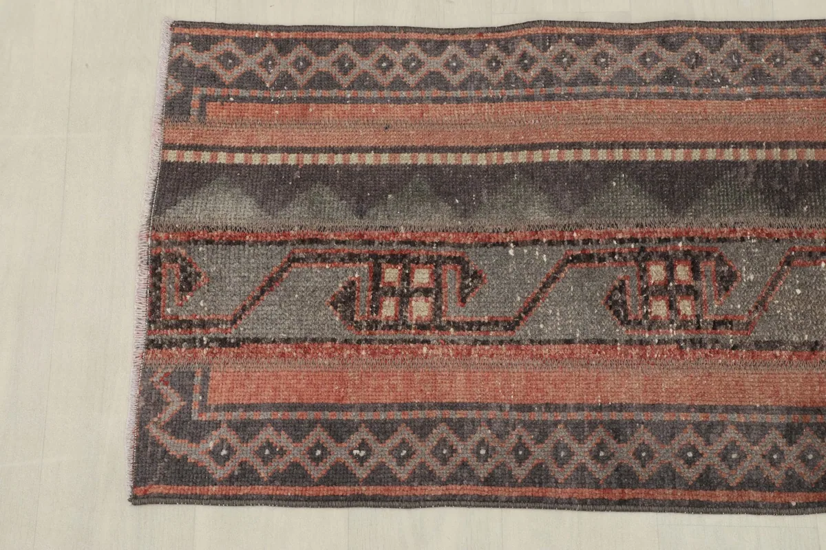 The other end of the rug, showcasing the consistent striped design and geometric border