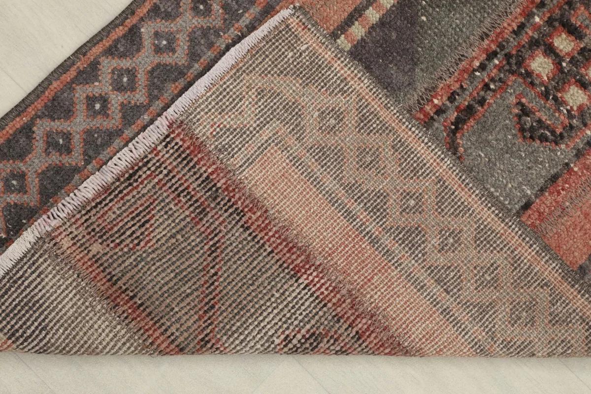 View of the rug's underside, revealing the hand-knotted cotton foundation