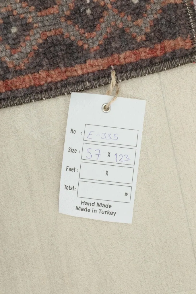 Product tag showing the rug's dimensions in centimeters and confirmation of handmade origin