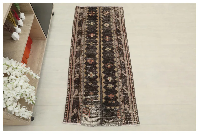 Full top view of the 2'1" x 4'10" charcoal and beige vintage Anatolian rug on a white background.