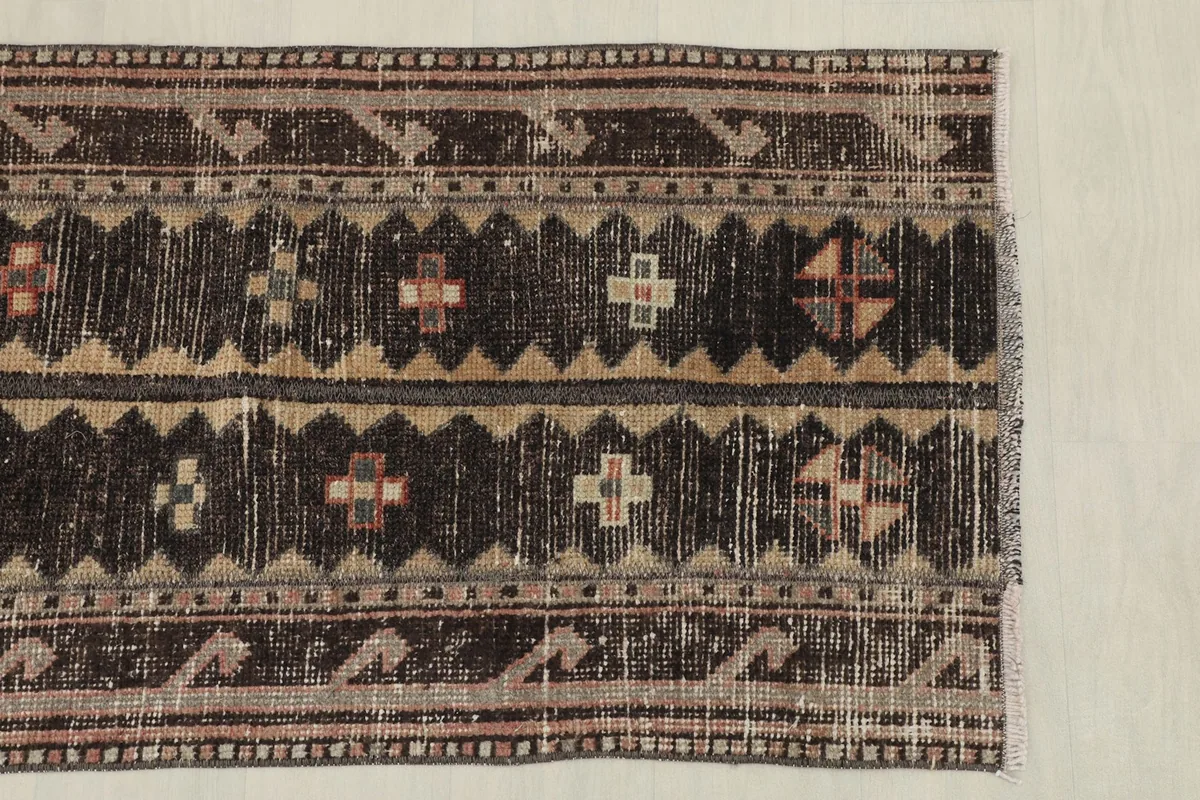 Overhead view of the upper half of the rug, displaying the repeated tribal patterns and color transitions.
