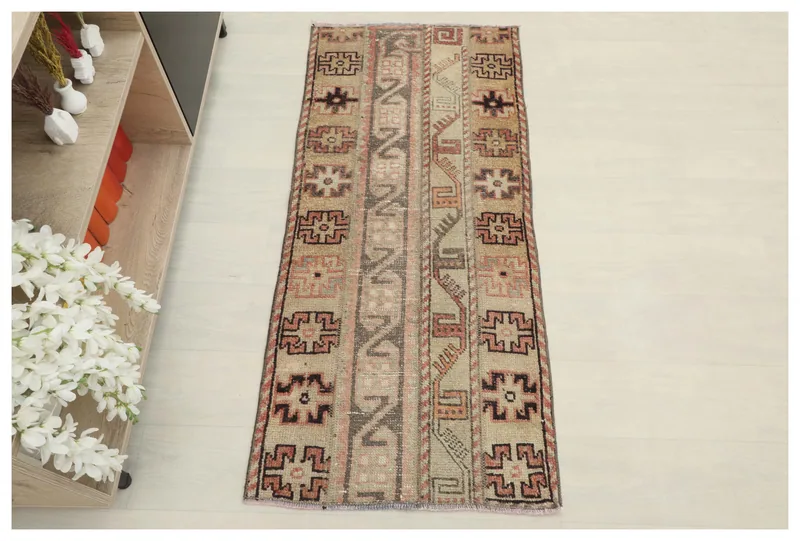 Full top view of the 2x4 tan and rose geometric Anatolian vintage rug on a white background.