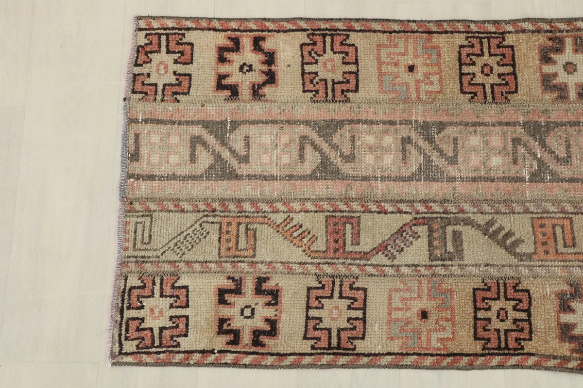 Detail of the opposite end of the rug, displaying the consistent geometric pattern and border.