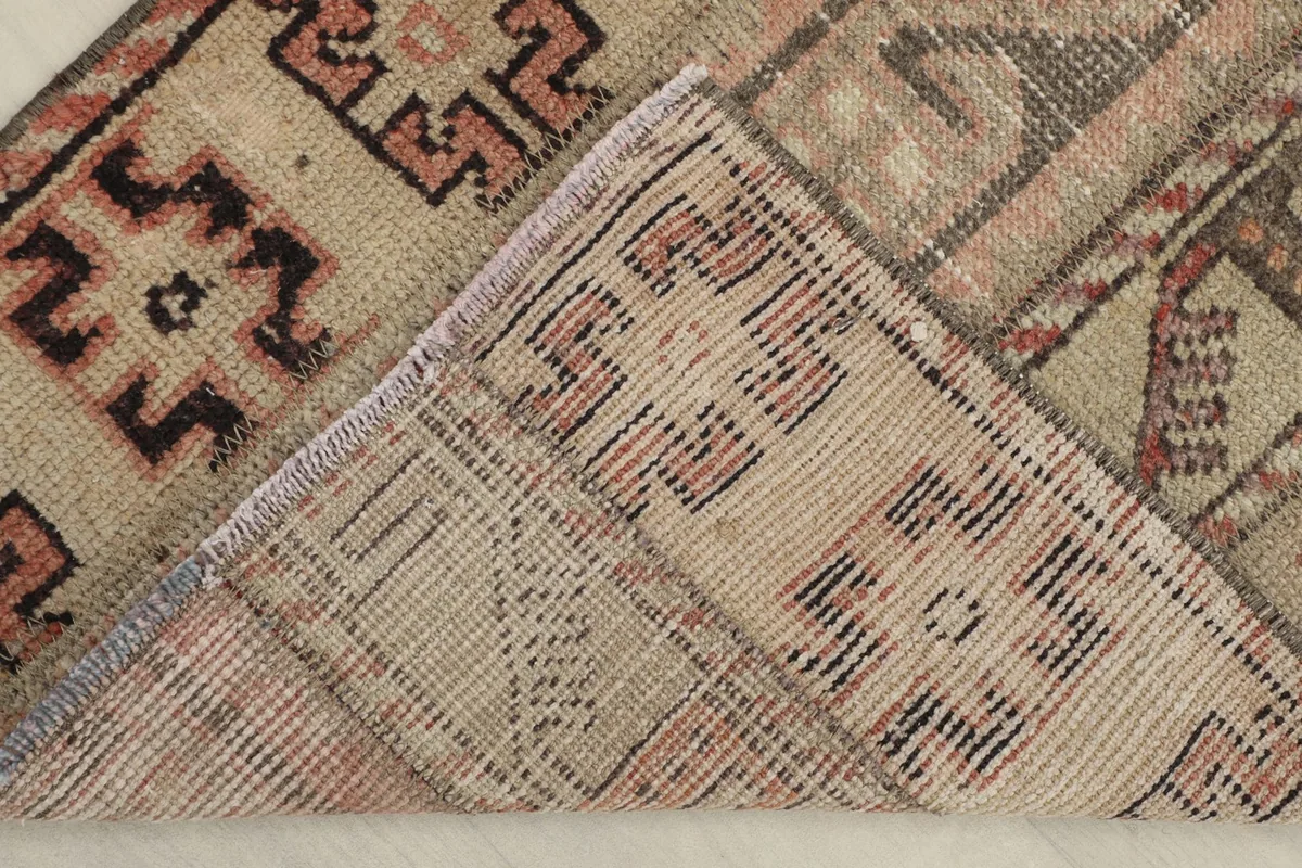 View of the back of the rug, revealing the tight hand-knotted construction and cotton foundation.