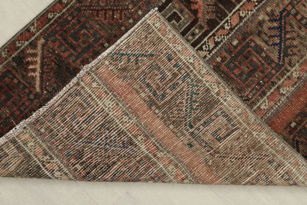 View of the back of the hand-knotted rug, revealing the cotton foundation and construction.