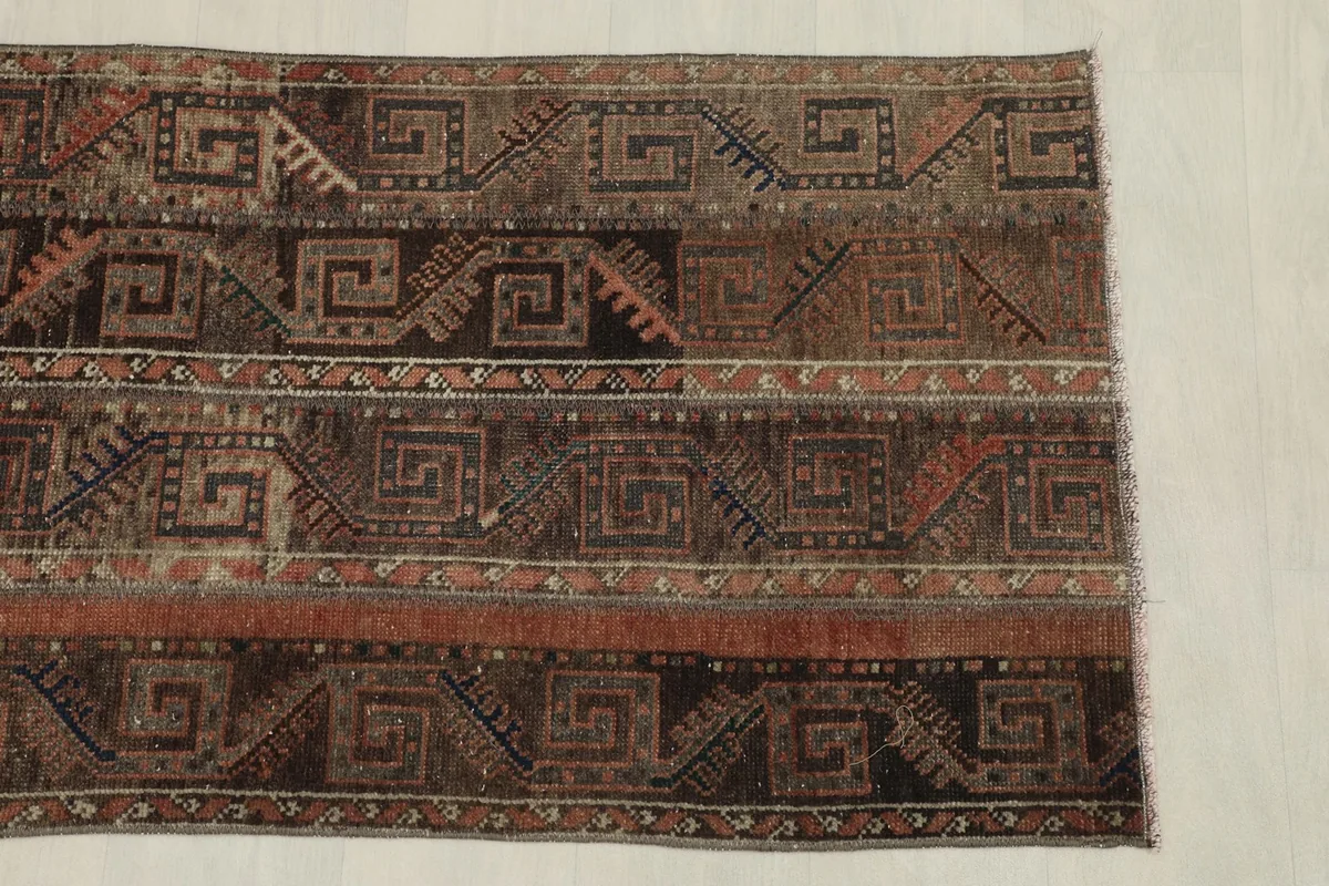 Overhead view focusing on the upper portion of the rug, displaying its unique design.