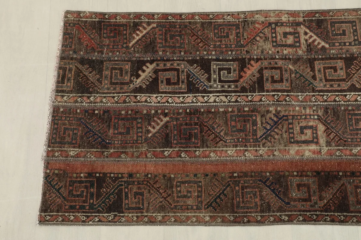 Overhead view focusing on the lower portion of the rug, displaying its unique design.