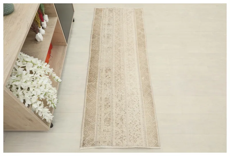 Full overhead view of the beige striped Anatolian runner rug on a white background.