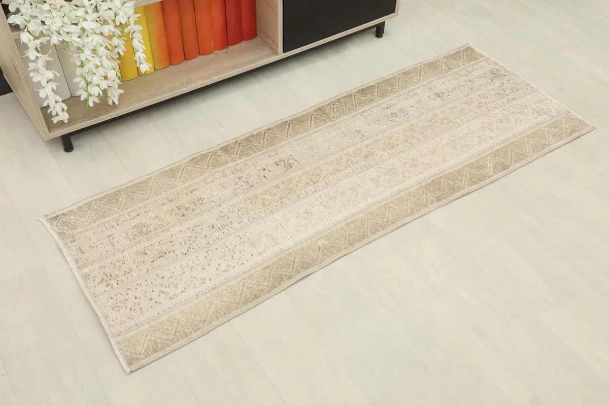 Angled overhead view of the vintage runner rug, showing its full length and striped pattern.