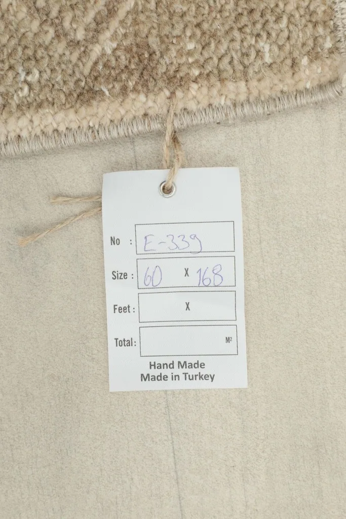 Close-up of the rug's tag, indicating it is hand-made in Turkey.