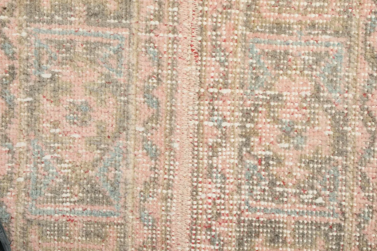 Detailed view of the hand-knotted wool pile and intricate geometric patterns.