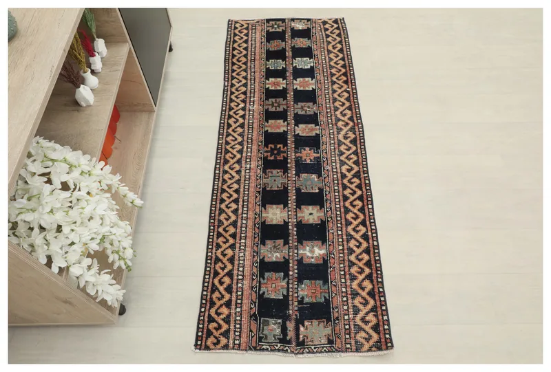 Full top view of the vintage navy geometric Anatolian runner rug on a white background.