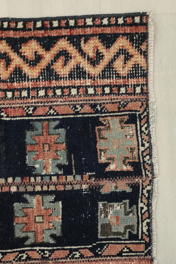 Close-up of the rug's border, showcasing the intricate patterns and the edge finish.