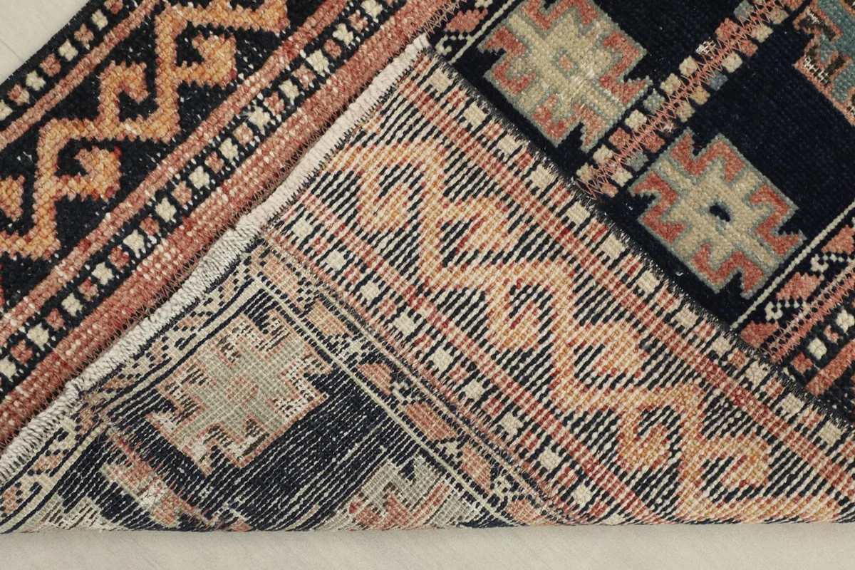 View of the back of the hand-knotted wool rug, revealing the cotton foundation and knotting.