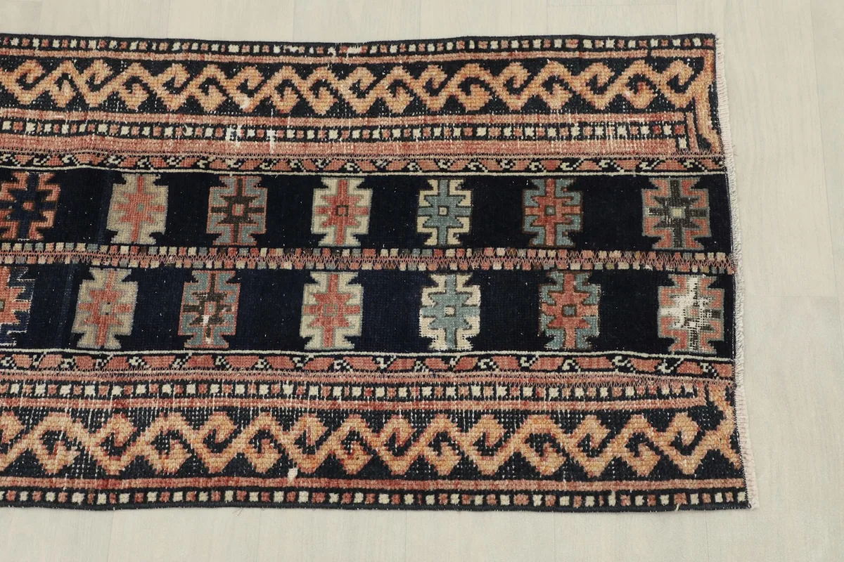 Overhead view of one end of the runner rug, highlighting the border and field design.
