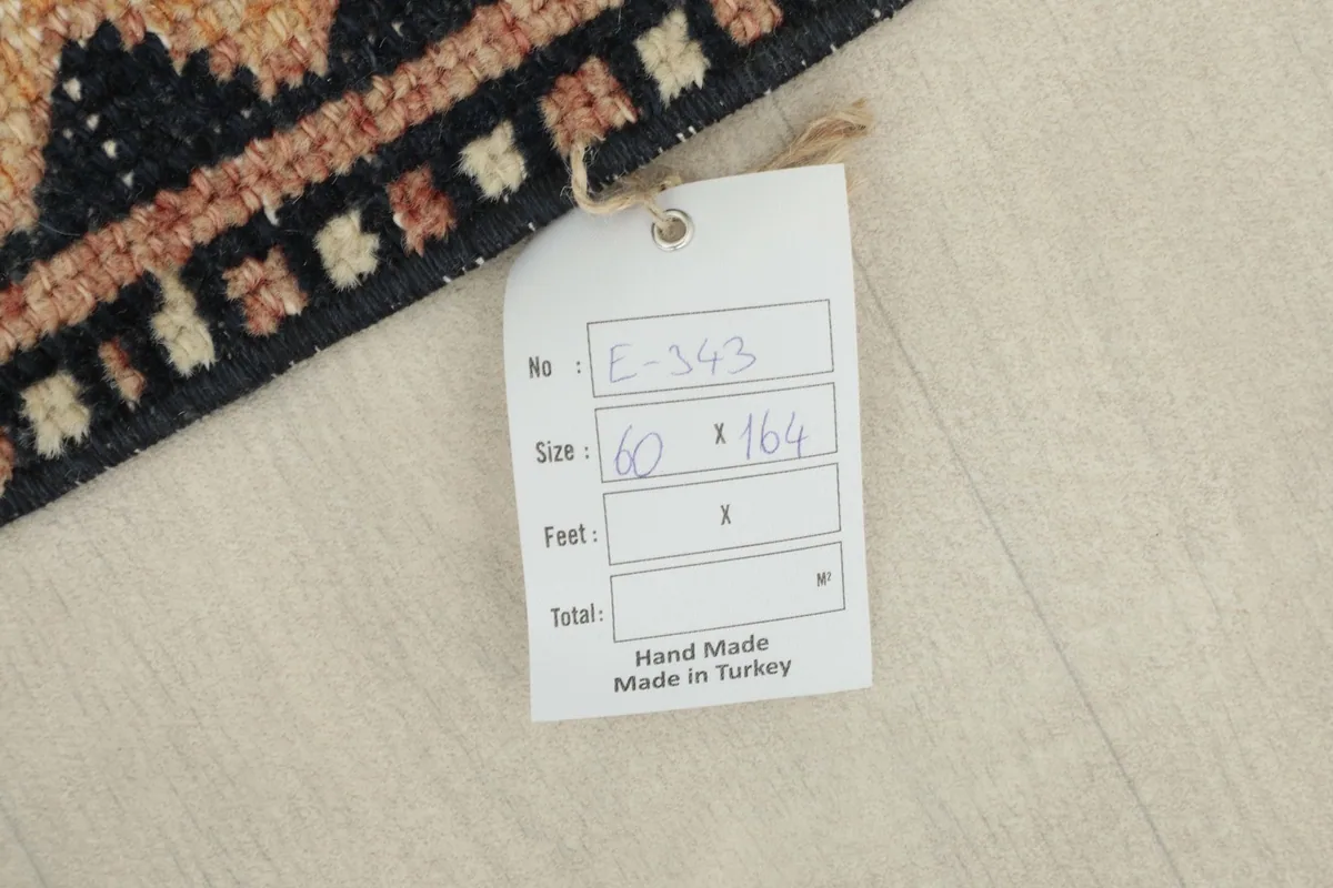 Close-up of the product tag indicating the rug's size and handmade origin from Turkey.