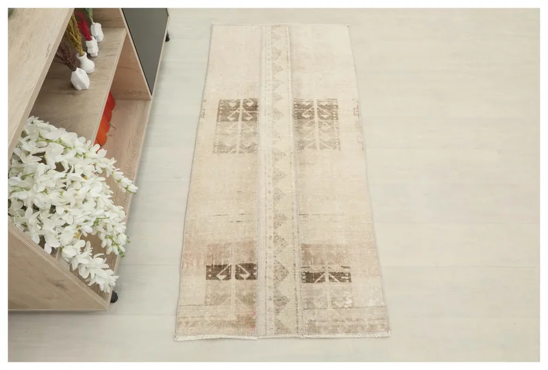 Full top view of the 2x5 beige and brown vintage Anatolian area rug on a light floor.