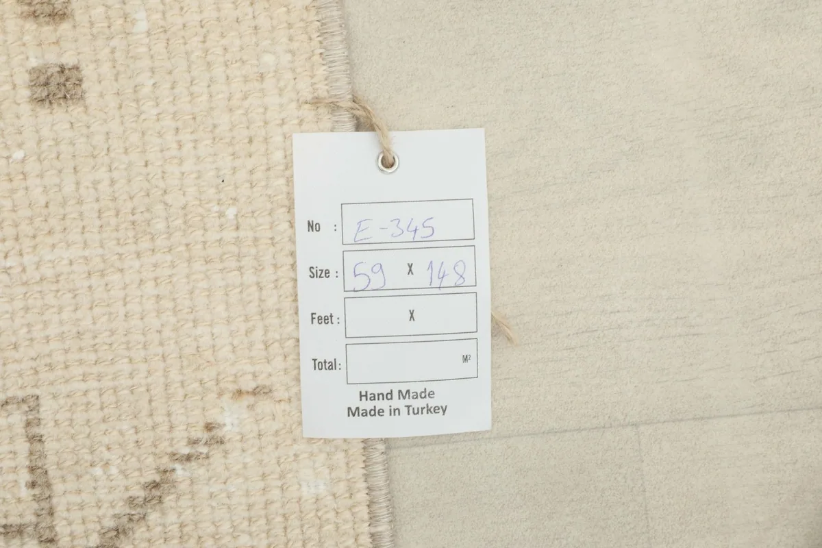 Handwritten size tag (59 x 148 cm) attached to the corner of the hand-knotted Anatolian rug.
