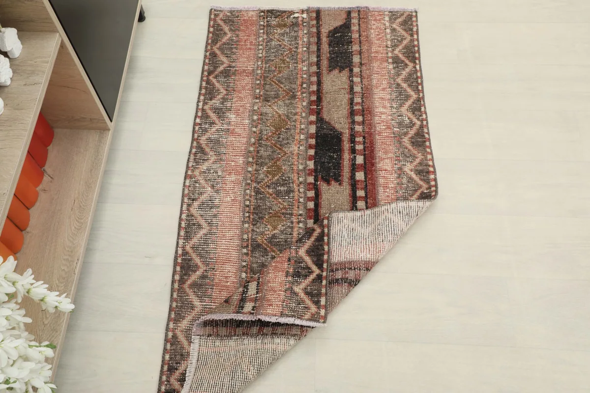 The rug partially folded, illustrating its flexibility and the overall appearance in a room setting.