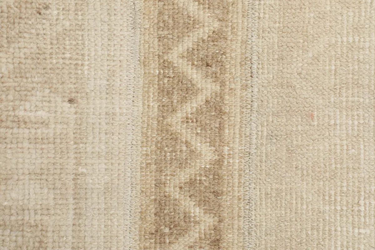 Macro shot of the low wool pile texture and the distinct geometric weave.