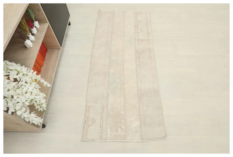 Full top view of the beige striped vintage Anatolian runner rug on a light floor.