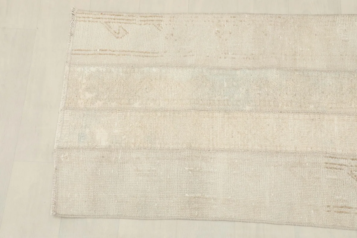 Detail view of the other end of the rug, highlighting the soft colors and texture.