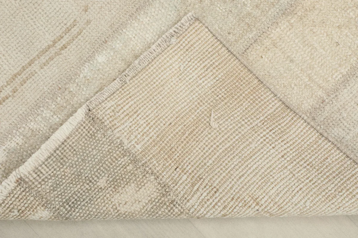 View of the back of the rug, revealing the cotton foundation and hand-knotted construction.