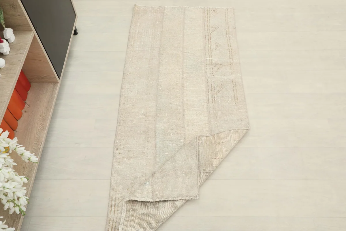 The beige runner folded to show its flexibility and thickness.