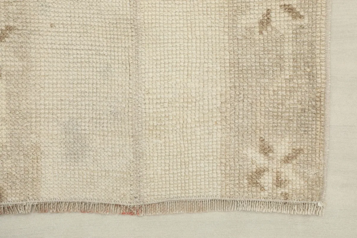 Detail of the runner's end, showing the subtle geometric pattern and fringe.