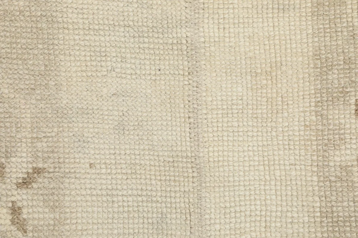 Close-up of the hand-knotted wool pile texture and cotton foundation.