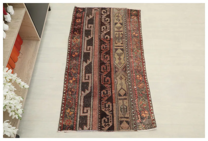 Full top view of the 2x4 brown and rust striped geometric vintage area rug