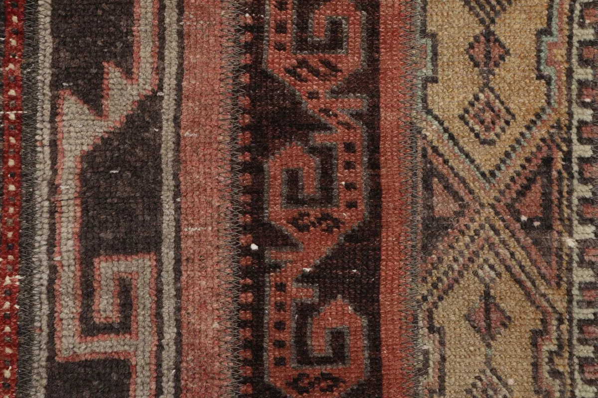 Detailed view of the intricate geometric motifs and color variations within the stripes