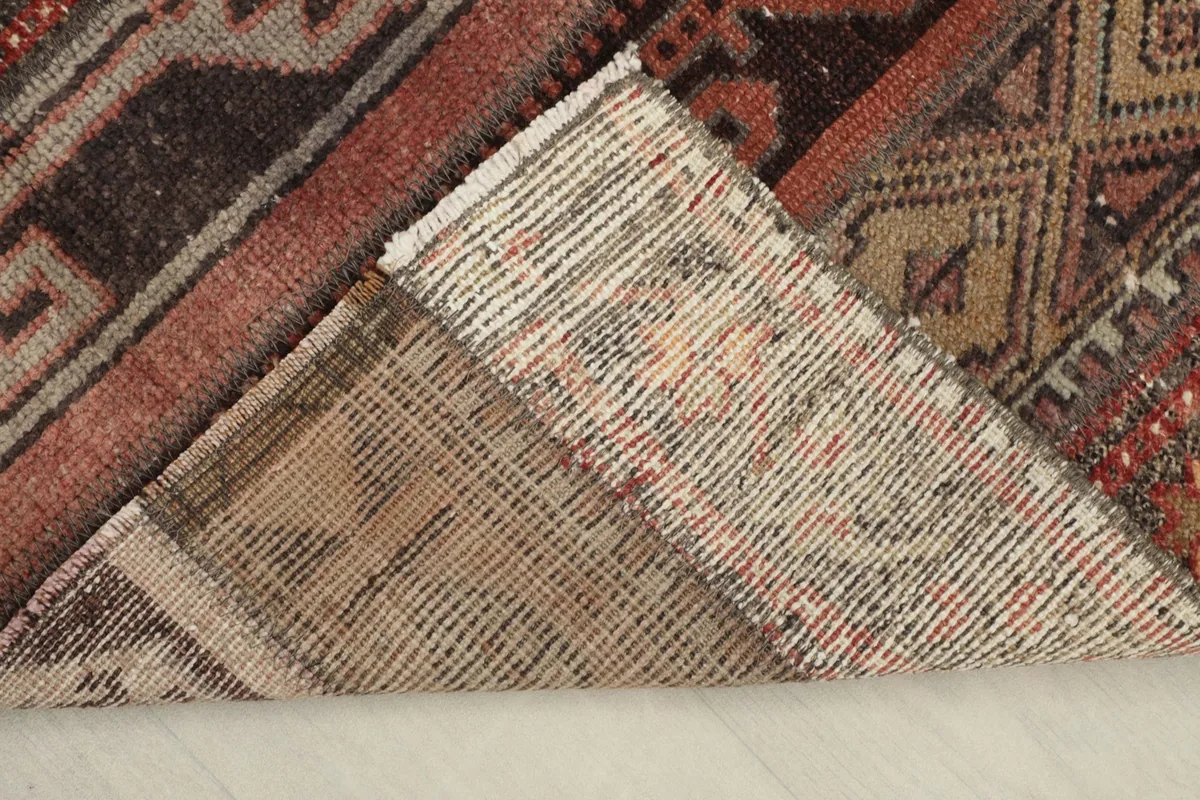 View of the back of the rug, revealing the hand-knotted cotton foundation