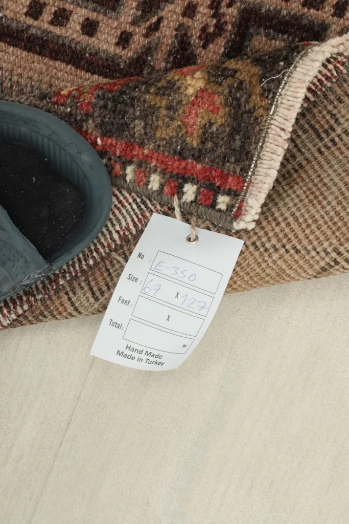 Close-up of the rug's label with size and origin details, next to the folded rug